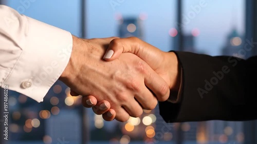 Business partners shaking hands in a modern office with a city skyline at dusk in the background, symbolizing a successful deal and partnership