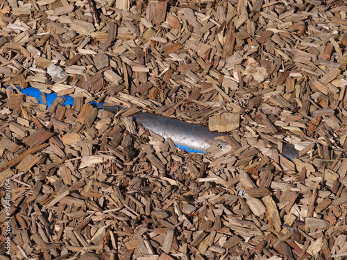 Bild auf Leinwand Iron bar hidden under wood chips