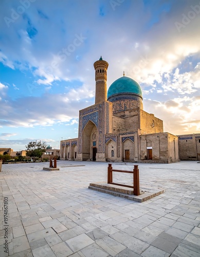 A stunning mosque with a tall minaret and blue dome, set against a dramatic sky with golden light