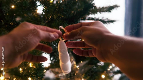 First person perspective decorating christmas tree with ornaments