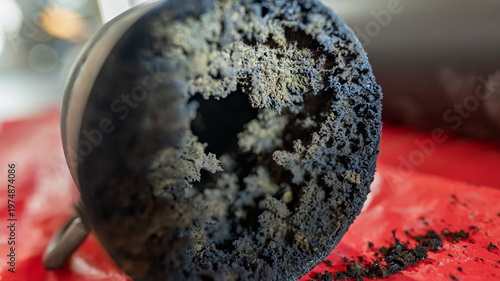 A section of a chimney pipe filled with soot.