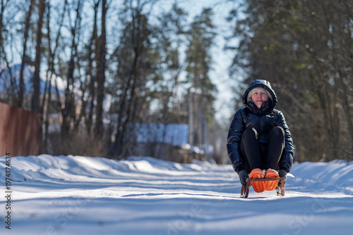 The woman got ready for some fun on a sled.