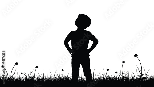 Silhouette of a young boy standing in a flower field and looking up at the sky for wonder and inspiration concept.