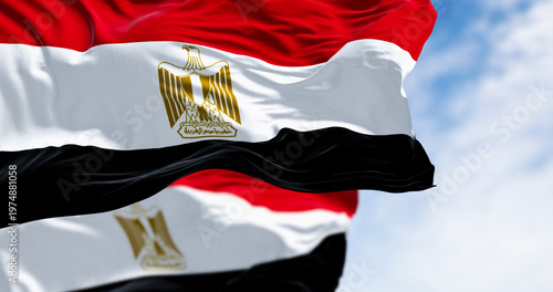 Foto National flags of Egypt waving in the wind on a clear day