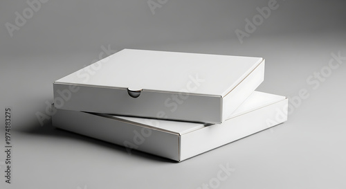 Stack of two blank white cardboard pizza boxes on a grey background, ready for mockup design