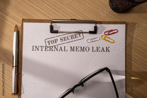  Top View of a Leaked Top Secret Internal Memo on a Clipboard with Glasses and Pen