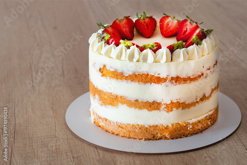 Top view of strawberry sponge cake with cream cheese frosting.copy space