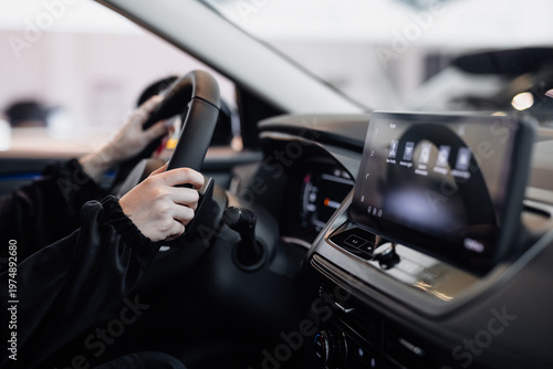 Tablou pe pânză Driver hands gripping steering wheel in modern car