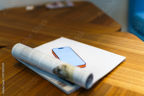 Smartphone mockup magazine wooden table soft focus