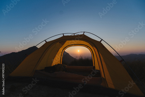 Camping tent high in the mountains. Hiking tour or wild camping and travel concept