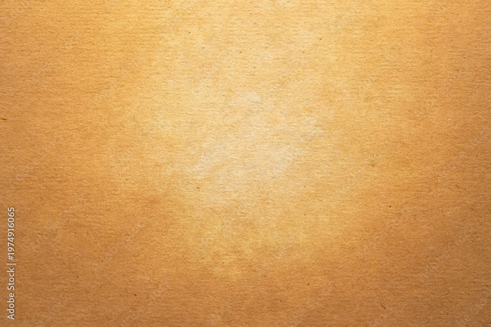 Fototapeta premium Warm golden brown textured canvas background. Vintage grunge painted studio backdrop with light center for elegant antique portrait design