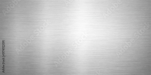 Industrial brushed stainless steel metal texture with a shiny silver metallic surface pattern on an aluminum titanium alloy plate sheet for grey textured material backgrounds