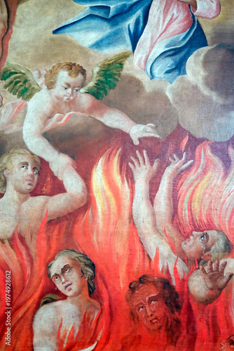 Saint Nicolas de Veroce church.  Baroque painting depicting tortured souls engulfed in flames, reaching upward toward divine salvation and redemption. Saint Nicolas de Veroce. France.