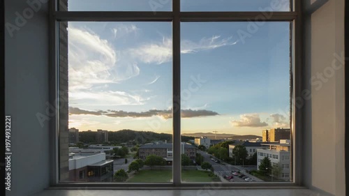 City view through window with moving clouds timelapse, urban skyline sunset scene