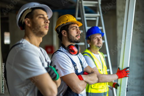 Photos Serious Construction Workers Looking Through Window