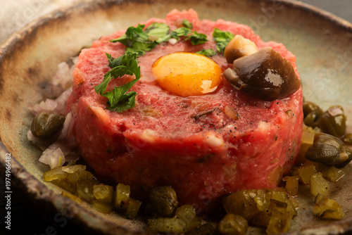 Beef Steak Tartare with Quail Egg on Handmade Ceramic Plate