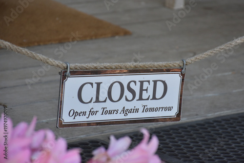 Closed sign attached to a rope, old signage