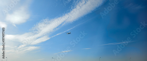 Passenger airplane taking off and climbing into a vast blue sky, leaving a contrail trail behind, symbolizing aviation, travel, and the journey of flight.