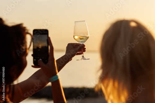 Wine Glass Raised During Sunset Celebration