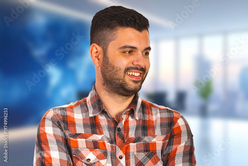 Man smiles warmly in bright office setting