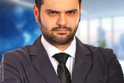 Confident businessman stands with arms crossed