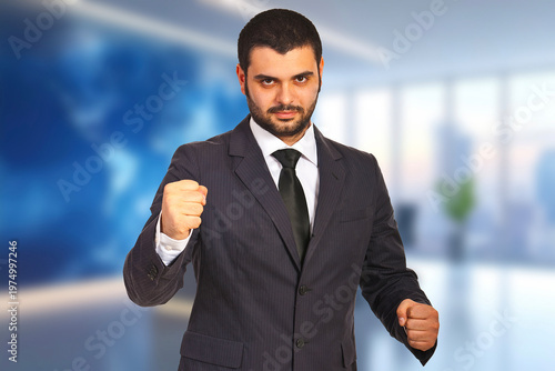 Confident businessman clenches fists