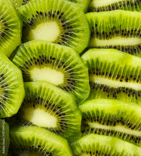  Juicy Kiwi slices as a background. Abstract photo of green kiwi fruit. Food and health background.  Round slices of fresj green fruit.