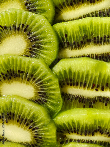  Juicy Kiwi slices as a background. Abstract photo of green kiwi fruit. Food and health background.  Round slices of fresj green fruit.