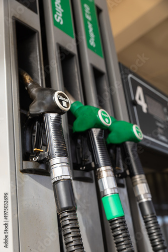 Gasoline and diesel distributor at the gas station. Gas pump nozzles. Petrol filling gun close-up at the gas station. Colorful Petrol pump filling nozzles. 