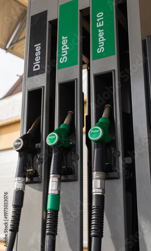 Gasoline and diesel distributor at the gas station. Gas pump nozzles. Petrol filling gun close-up at the gas station. Colorful Petrol pump filling nozzles. 