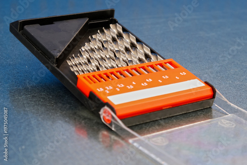A set of drills for drilling metal in a plastic case.