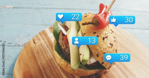 Showing single seeded slider sitting on wood board with avocado patty red pepper and blue icons