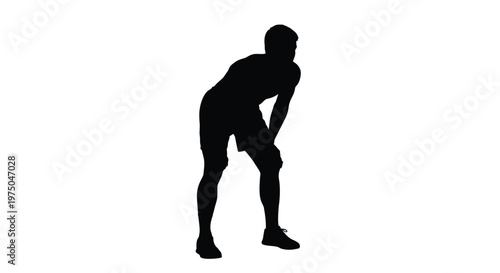 A lone athlete rests hands on knees in stark silhouette