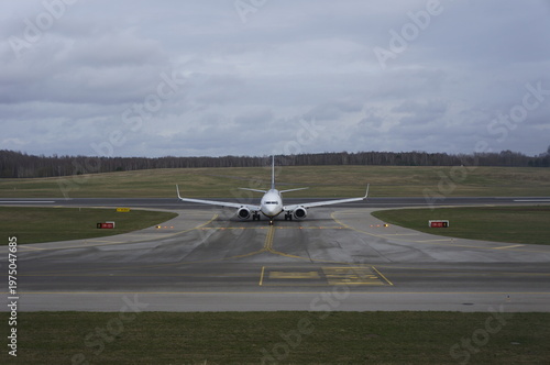 Photos A professional front-view shot of a commercial passenger airplane just after a successful landing at an international airport
