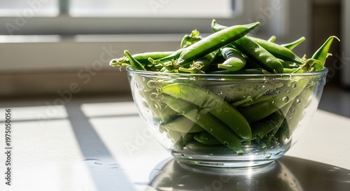 Fresh Garden Peas In A Glass Bowl Illuminated By Sunlight