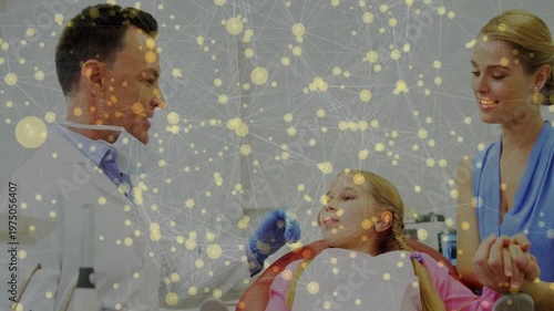 Dentist greeting child in dental chair starting teeth exam ensuring oral health under lamp