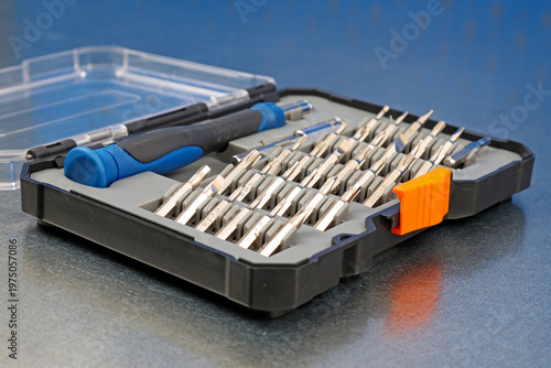 A set of metal bits for installation work in a plastic case.