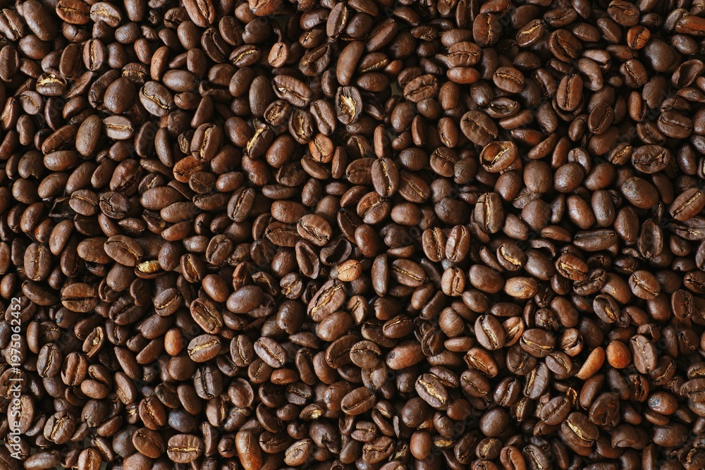 Fototapeta premium Roasted coffee beans background, dark brown espresso bean texture, organic arabica coffee seeds top view, aromatic caffeine ingredient for cafe menu