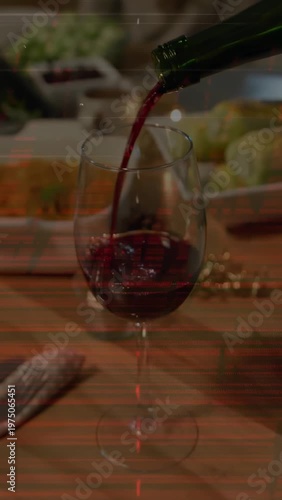 Vertical video: Green bottle pouring red wine into glass on table, creating ripples for restaurant