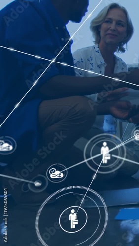 Vertical video: Pair sharing notes on floor while network HUD rising, team celebrating business win