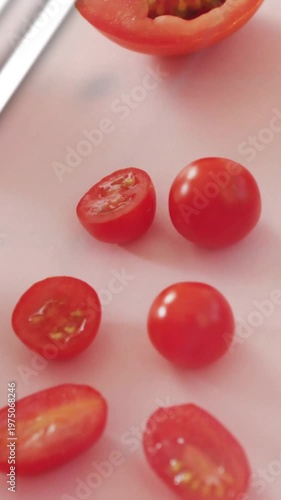Vertical video: Fork lifting tomato, tomatoes shining, cyan charts sliding over produce for food ad