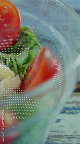 Vertical video: Camera pulling close glass bowl, tomato wedge and greens, overlay showing food ad