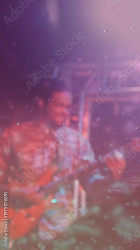 Vertical video: Sparkle clearing, revealing musician playing guitar for concert crowd filming phone