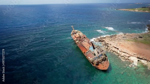 Aerial view of the edro iii, a large cargo ship shipwrecked and rusting on the rocky coast