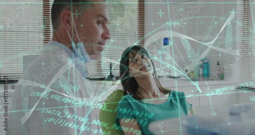 Dentist leaning toward patient, speaking and activating DNA hologram over dental chair for exam