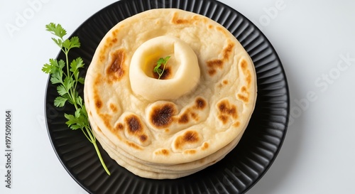 Stack of naan bread with butter on top and parsley  delicious indian food
