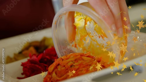 Vertical video: Hand tilting bowl, plating carrot on divided plate for food, gold stars overlaying