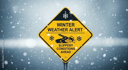 Yellow winter weather alert road sign with slippery conditions ahead on snowy background