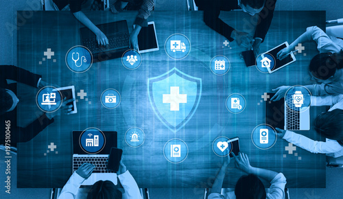 Obraz na plátně A dynamic meeting scene showcasing professionals collaborating on health technology advancements, featuring multiple laptops and digital healthcare icons for innovative solutions