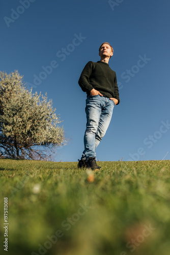Man standing on hill against blue sky lifestyle concept